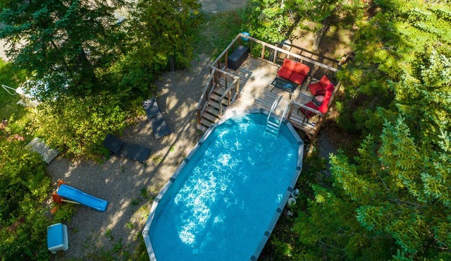 Nestled in the heart of nature, La Romane combines contemporary design, warmth, and comfort — featuring a private spa year-round, billiard room, and a heated pool in summer. in Val-David